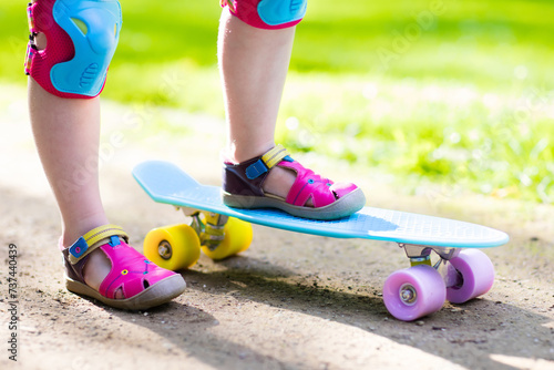 Child riding skateboard in summer park © famveldman