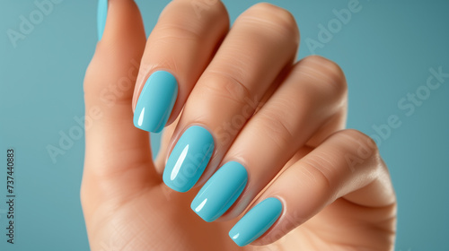 Elegant Hand Showcasing Aqua Blue Manicure. Beauty and Nail Care Concept.