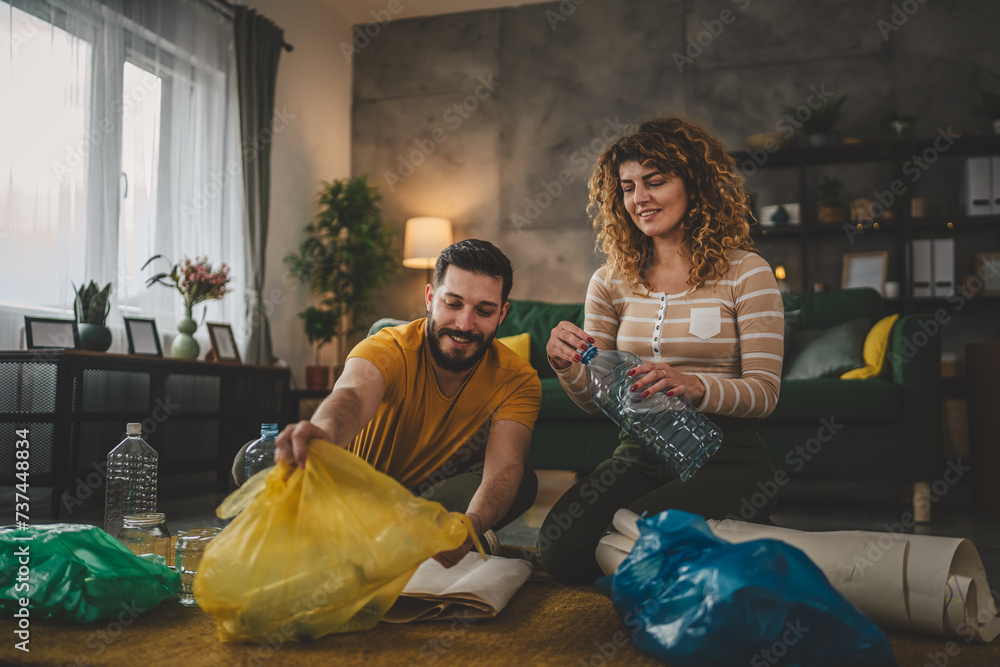 husband and wife recycle at home sorting waste plastic paper and glass husband and wife recycle at home sorting waste plastic paper and glass