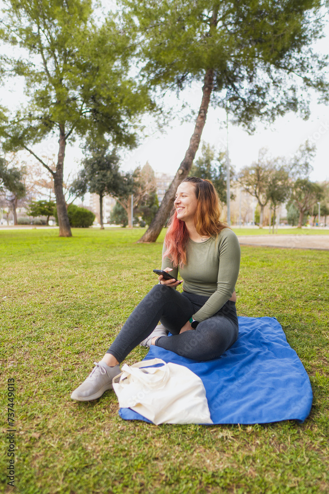 Woman sitting outdoors on a blanket