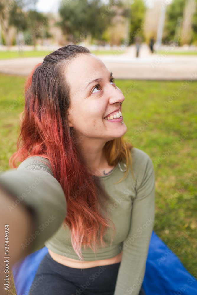 Woman smiling and looking away while taking a selfie Woman smiling and looking away while taking a selfie