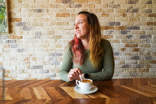 Woman smiling, sitting in a cafe