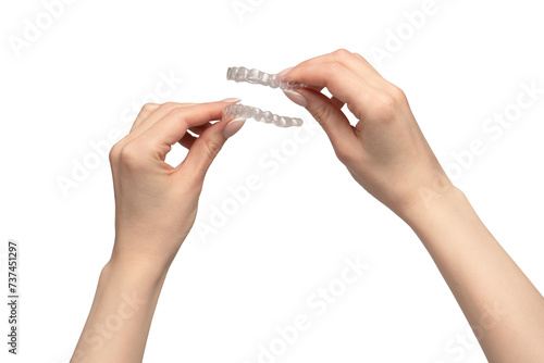 Transparent mouth guard in a woman's hand isolated on white background. photo