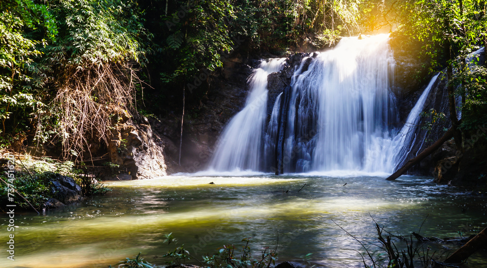 Obraz premium Thung Nang Khruan Waterfall with sunlight in Lam Khlong Ngu national park view in Kanchanaburi Province,Thailand.Travel concepts.