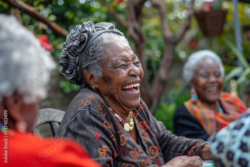 old Black lady laughing heartily with friends over a game of cards, capturing a moment of joy and camaraderie