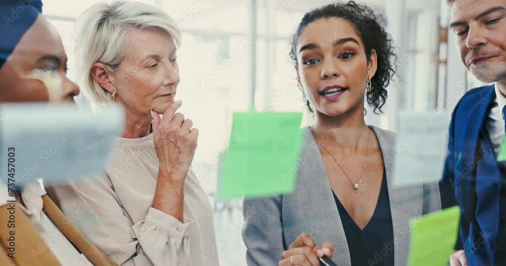 Meeting, coaching and sticky note with business woman talking to team in office for vision development. Collaboration, glass and seminar with employee group in workplace for strategy or game plan