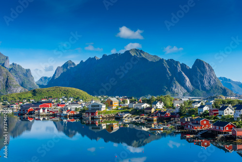 Perfect reflection of the Reine village on the water of the fjord in the Lofoten Islands,  Norway photo