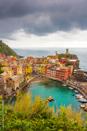 View of the colorful town of Vernazza under a cloudy sky, Cinque Terre, Liguria, Italy
