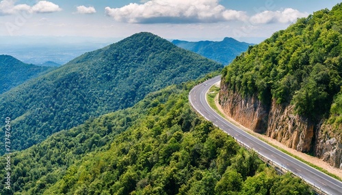 aerial view of the road on the mountain with forest arround photo