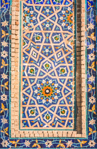 Facade of the Gur Emir mausoleum with mosaic brick walls in the ancient city of Samarkand in Uzbekistan, oriental architecture