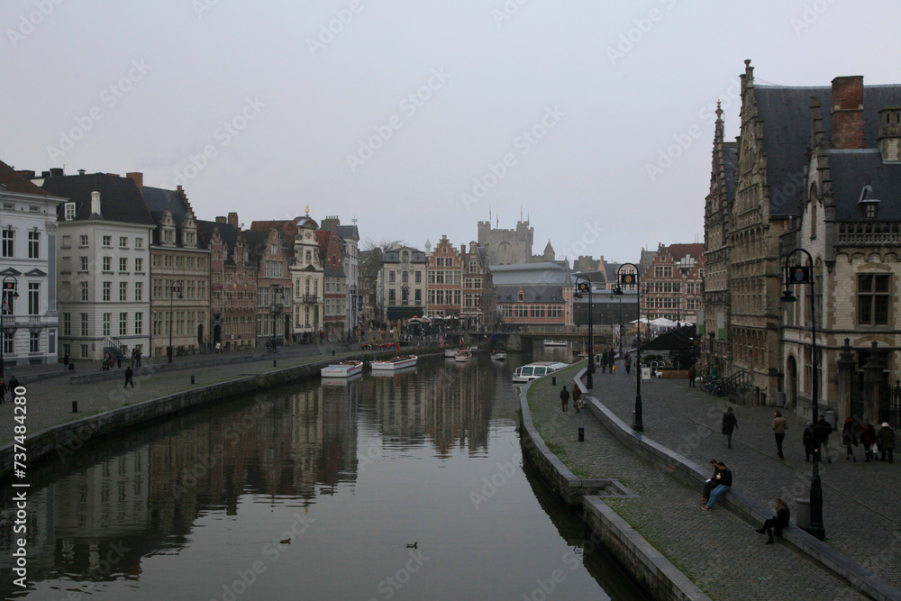 old colorful traditional houses along the canal and boats in Ghent, Belgium