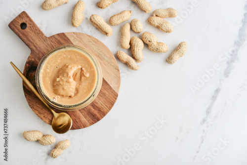 Creamy and smooth peanut butter in jar photo
