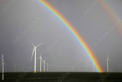 Rainbow above a offshore windpark, Breezanddijk, Holland photo