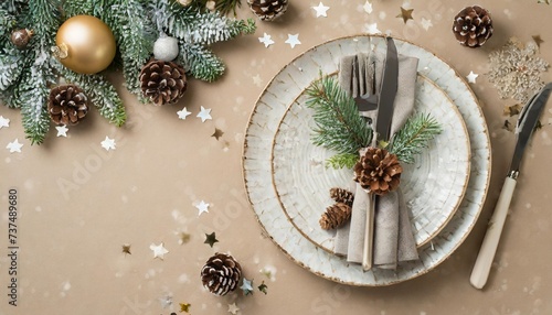 elevate your christmas dining experience top view photo of plates cutlery tree ornaments frosty fir branches cones stars on beige background with promo zone