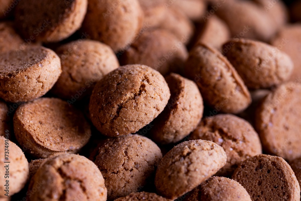 A tasty food portrait of a pile of delicious traditional dutch snacks called pepernoten or pepernuts. The gingerbread treat is a tradition during the holidays and sinterklaas or saint nicholas. A tasty food portrait of a pile of delicious traditional dutch snacks called pepernoten or pepernuts. The gingerbread treat is a tradition during the holidays and sinterklaas or saint nicholas.