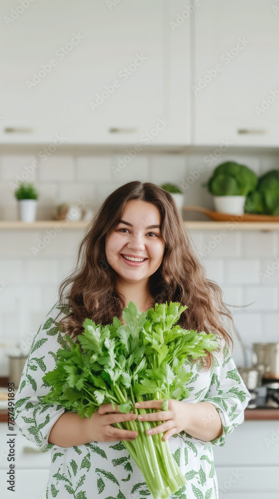 fat overweight smiling young woman with a bunch of greens on the background of a white kitchen, proper nutrition, salad, celery, weight loss, lifestyle, health, girl, food, cooking fat overweight smiling young woman with a bunch of greens on the background of a white kitchen, proper nutrition, salad, celery, weight loss, lifestyle, health, girl, food, cooking