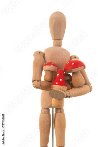 Wooden mannequin with red mushrooms