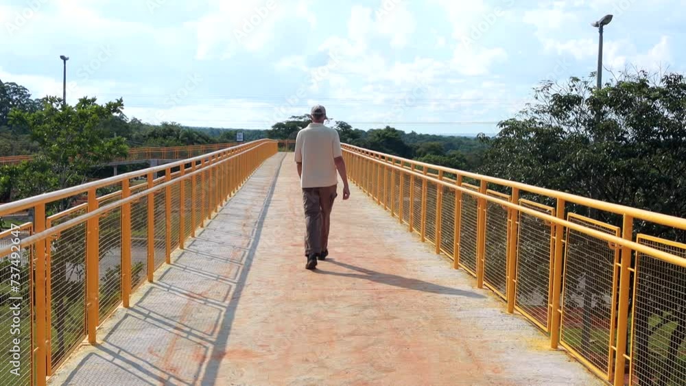Man Walking Across a Newly Constructed Elevated Pedestrian Walkway in Northwest Brasilia Man Walking Across a Newly Constructed Elevated Pedestrian Walkway in Northwest Brasilia