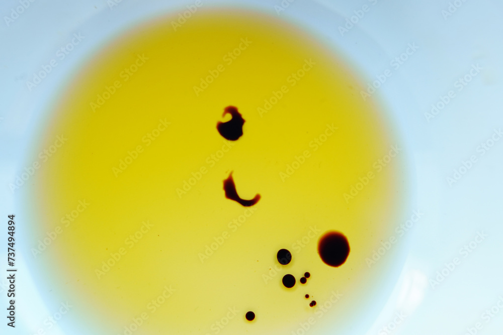 Fototapeta premium Drops of balsamic vinegar in a bowl of olive oil