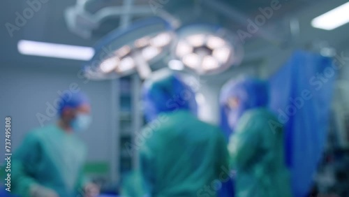 Medical team working in surgical room. Blurred image of doctors cooperating at operational table. photo