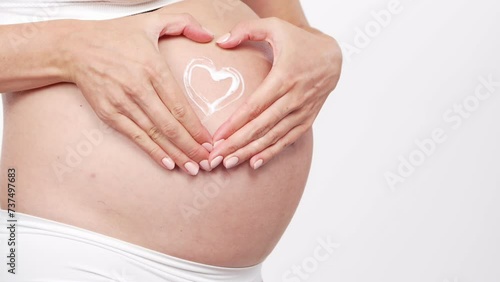 Wallpaper Mural Young, happy and healthy pregnant woman in front of white background. Studio video. Baby expectation, pregnancy and motherhood. Torontodigital.ca