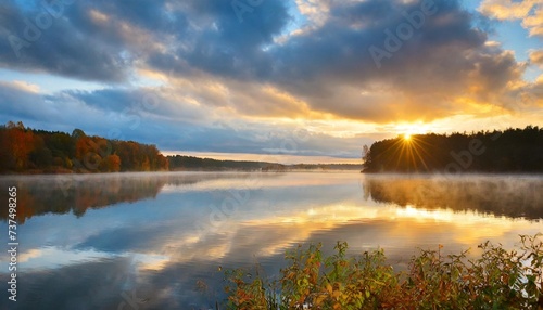 sunrise over the lake on a cloudy autumn day