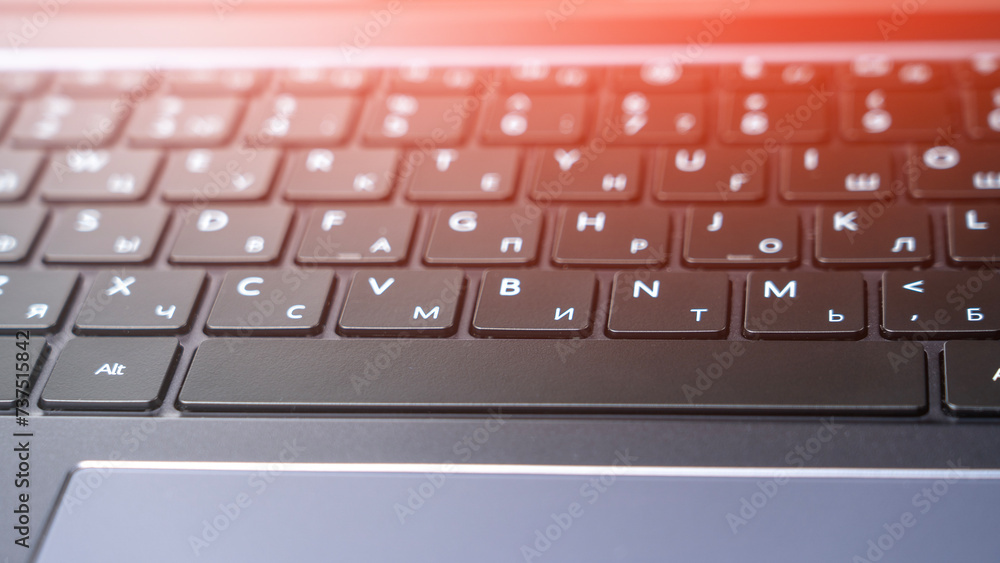 Laptop keyboard with Russian layout, Spacebar close-up, close-up tinted image.