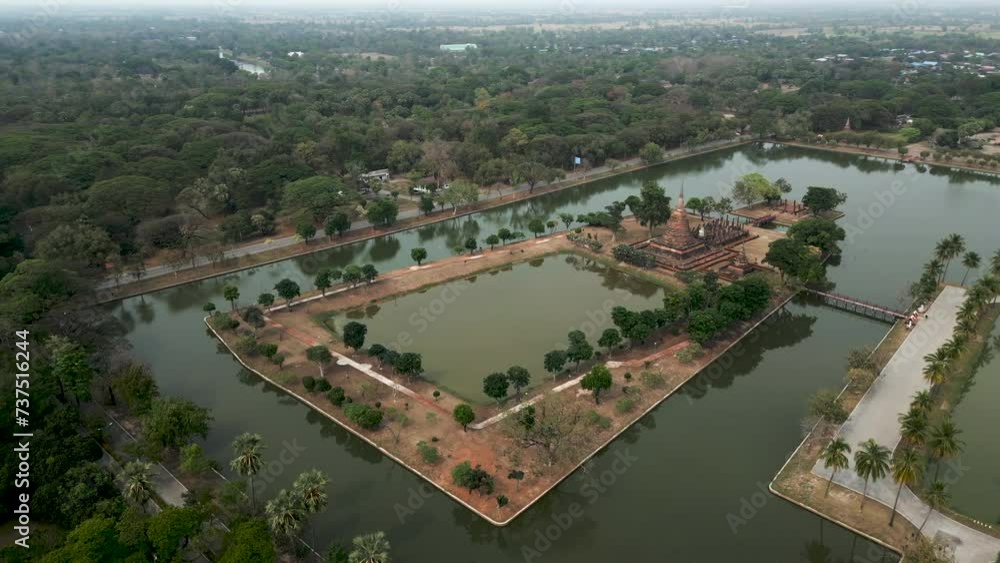 Birds eye view of Buddhist monument surrounded by water Birds eye view of Buddhist monument surrounded by water