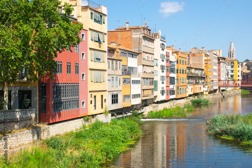 Street with balcony in the old summer city in Spain near the river.