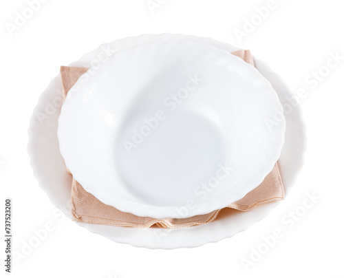 Dishes and cutlery are prepared for dinner. Plates for first and second courses. Isolated over white background