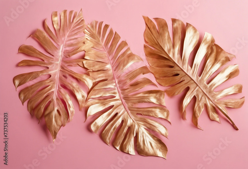 Painted Golden tropical leaves on pink pastel background Natural Creative layout 