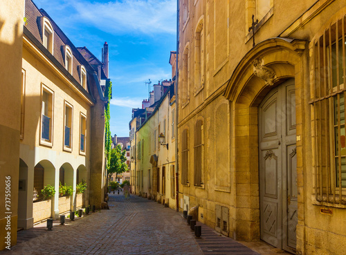 Fototapeta Naklejka Na Ścianę i Meble -  View of typical narrow streets in old historic center of French city of Dijon in summer day.