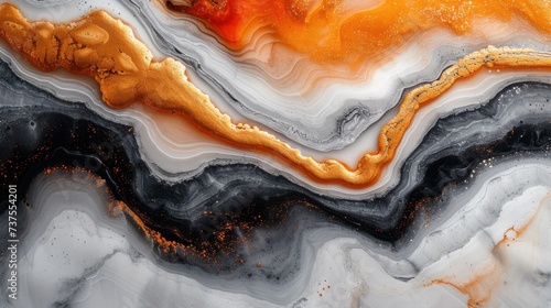 a close up of a black, orange, and white marble with a gold line in the middle of it.