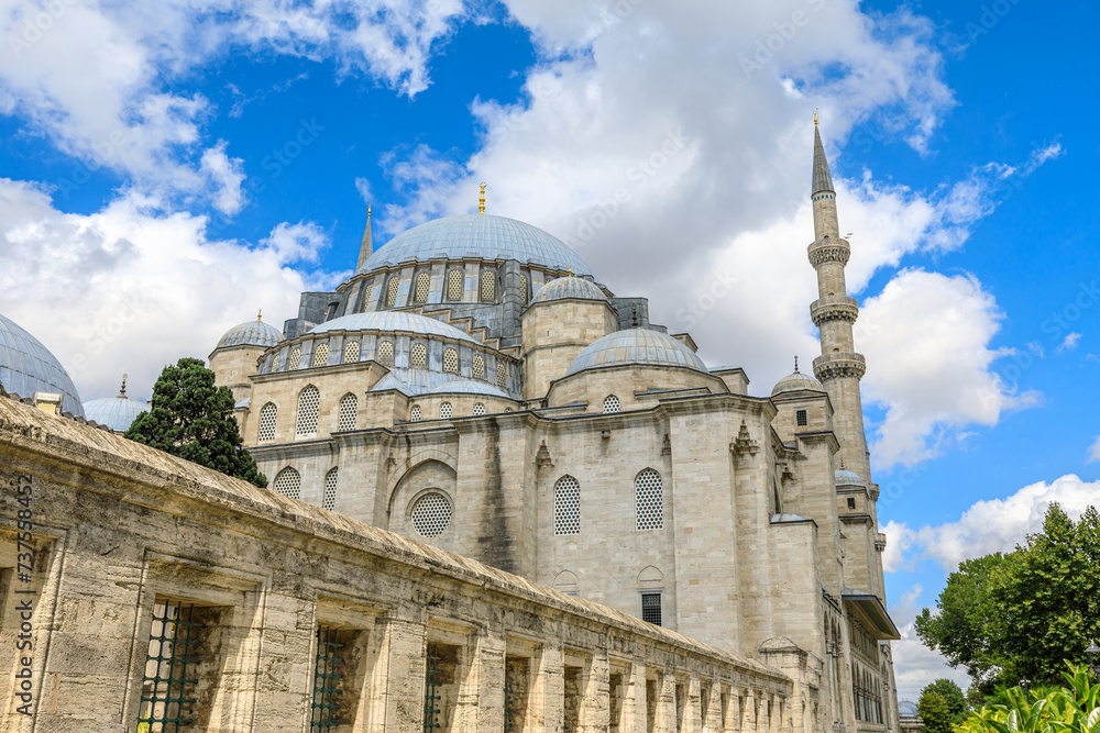 Suleymaniye Mosque in Istanbul, Turkey. Blue cloudy sky creates a contrast with the stone structure of the mosque. Commissioned by Sultan Suleyman the Magnificent in 16th century.