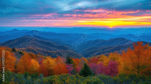 a sunset view of a mountain range with trees in the foreground and colorful foliage in the foreground, with mountains in the background.