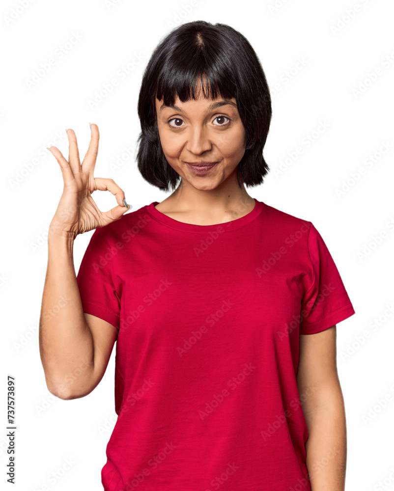 Young Hispanic woman with short black hair in studio cheerful and confident showing ok gesture. Young Hispanic woman with short black hair in studio cheerful and confident showing ok gesture.