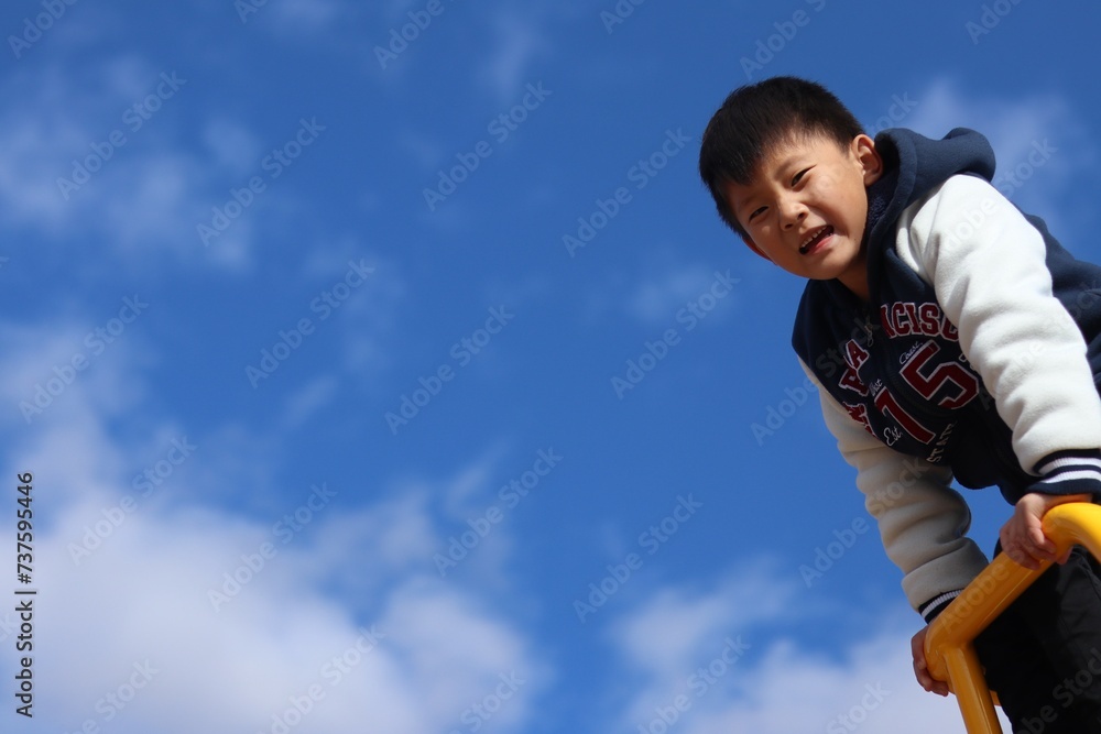 a young boy climbing up a yellow ladder