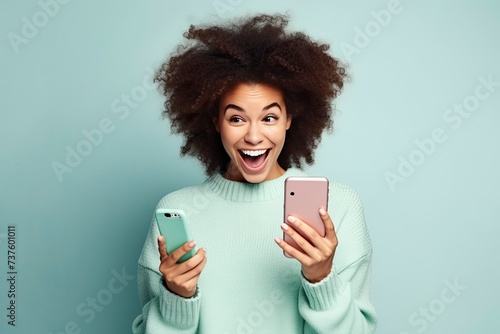 fun young woman wear knitted sweater hold in hand use mobile cell phone look aside on workspace isolated on plain pastel light blue cyan background studio portrait - generative ai photo