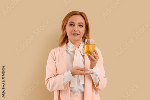 Mature woman with glass of ...