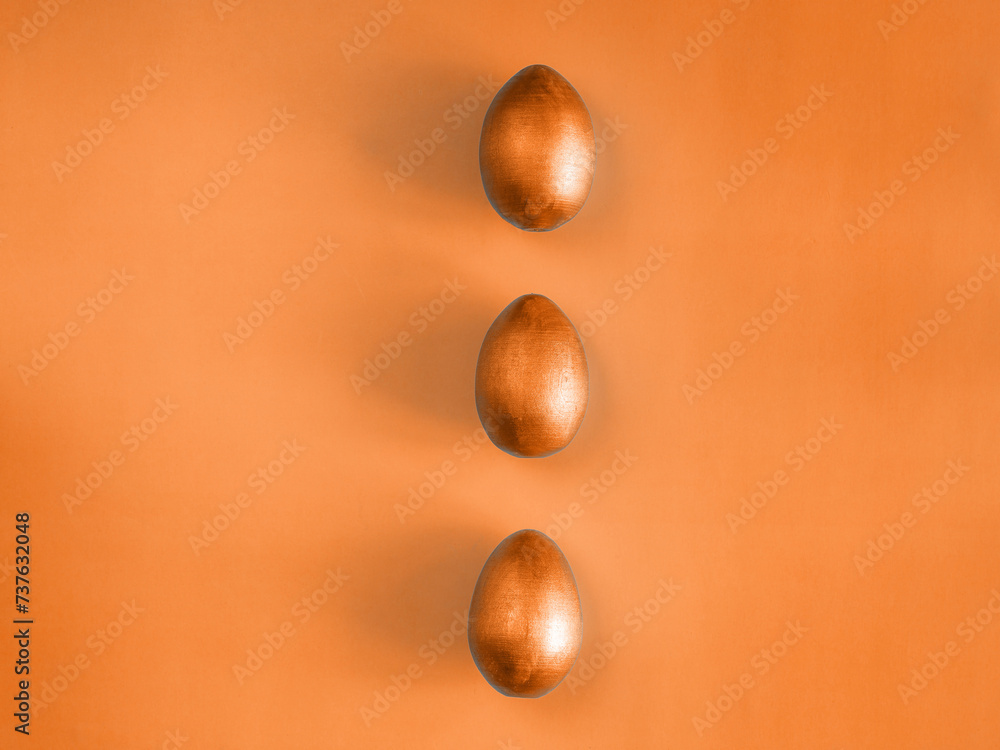 Three eggs on color trend 2024 peach fuzz background. Design, visual art, minimalism. Flat lay top view, copy space. Happy Easter monochrome concept. Aesthetic look. Contemporary style Three eggs on color trend 2024 peach fuzz background. Design, visual art, minimalism. Flat lay top view, copy space. Happy Easter monochrome concept. Aesthetic look. Contemporary style