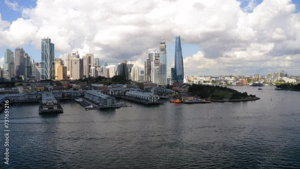 Aerial Beautiful View Of Modern Buildings In City, Drone Flying Forward Over Sea Under Cloudy Sky - Sydney, Australia Aerial Beautiful View Of Modern Buildings In City, Drone Flying Forward Over Sea Under Cloudy Sky - Sydney, Australia
