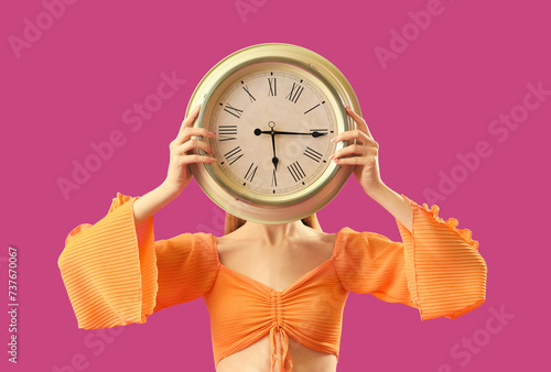 Young woman with alarm cloc...