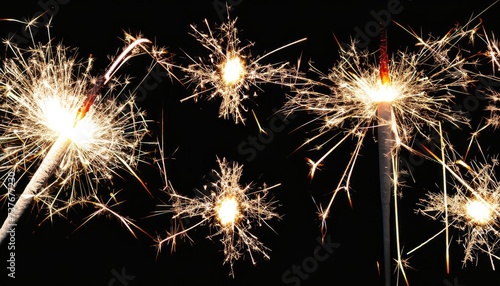 Glittering burning sparkler against blurred bokeh light background