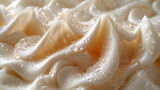 Closeup of silky layers of cream and coffee creating a delicate contrast of textures.