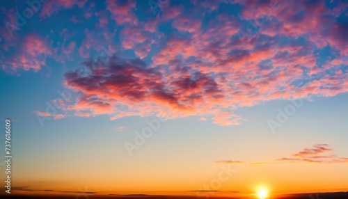 Summer sunrise with beautiful vibrant high clouds being illuminated by the rising sun