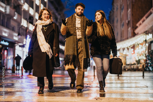 Young friends enjoying a winter evening walk on a city street.