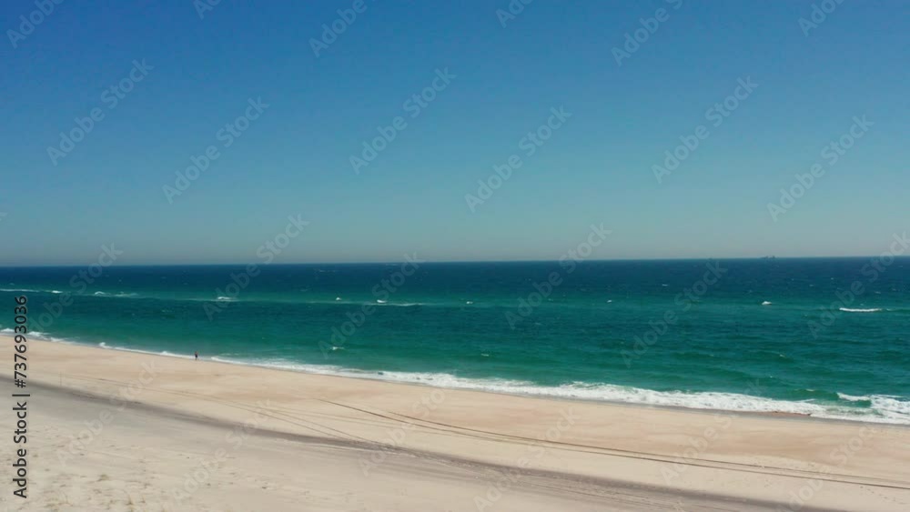 Drone shot captures the serene beauty of Southhampton Beach in the Hamptons, overlooking the vast sea and ocean, offering a breathtaking view from New York. Drone shot captures the serene beauty of Southhampton Beach in the Hamptons, overlooking the vast sea and ocean, offering a breathtaking view from New York.