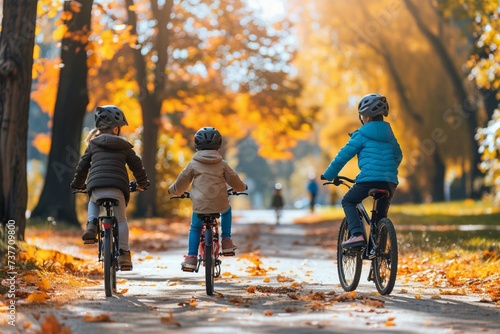 Young family bike riding in sunny autumn park
