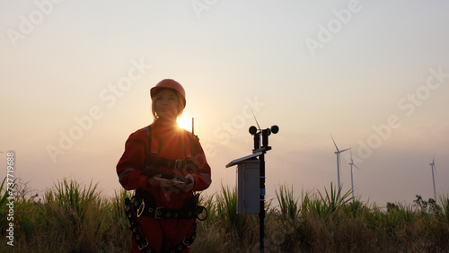 young female engineer holding a tabletstanding beside agricultural sugarcane and wind turbine morning sun star light effect background, photo