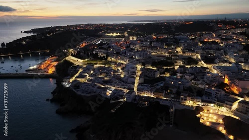 Illuminated Coastal City Of Albufeira At Night In Algarve, Portugal. aerial shot
